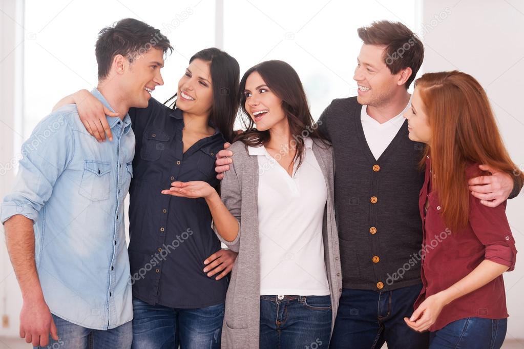 Group of cheerful young people standing close to each other