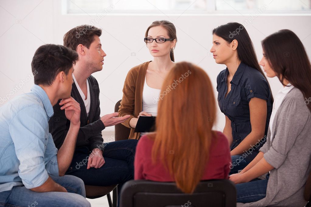 Group of people sitting close to each other and communicating