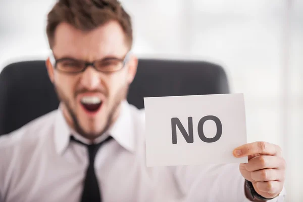 Furious young man in shirt and tie touching his temple with finger gun — Stock Photo, Image