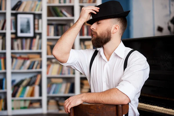 Portrait of bearded men sitting in front of his piano with closed eyes — Stock Photo, Image