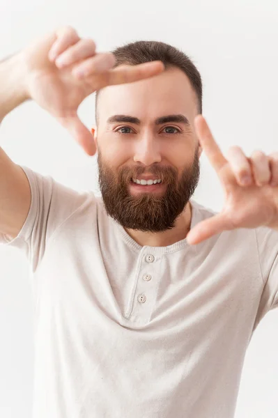 Bearded man focusing on you and smiling — Stock Photo, Image