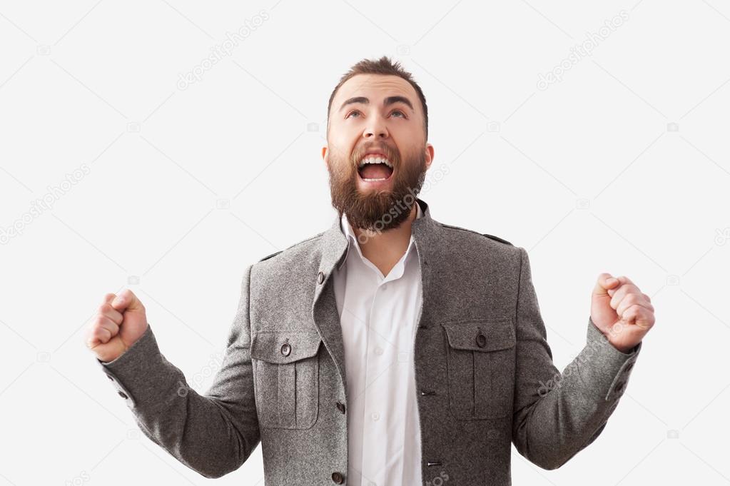Bearded man screaming with hands up
