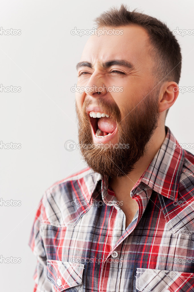 Bearded man screaming with eyes closed