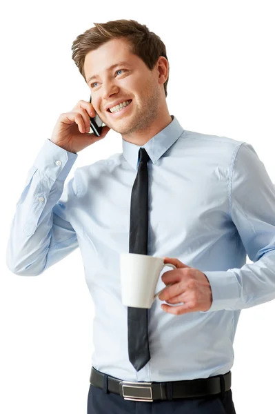 Hombre con camisa y corbata hablando en el teléfono móvil y sosteniendo una taza de café — Foto de Stock