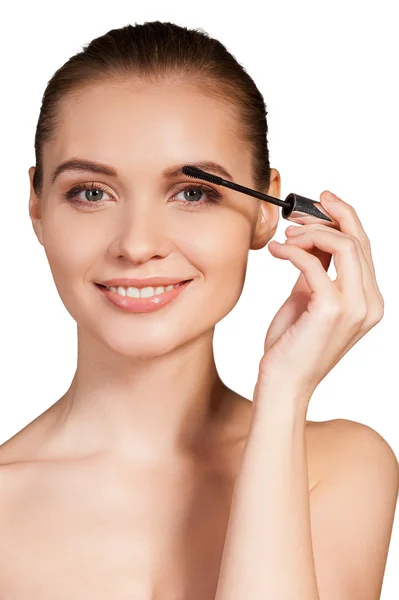 Woman holding make-up brush on eyebrow and smiling — Stock Photo, Image