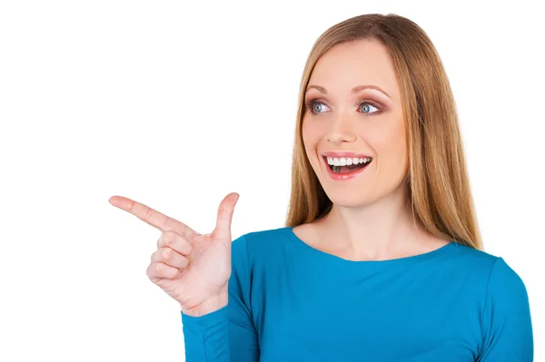 Woman pointing away and smiling — Stock Photo, Image