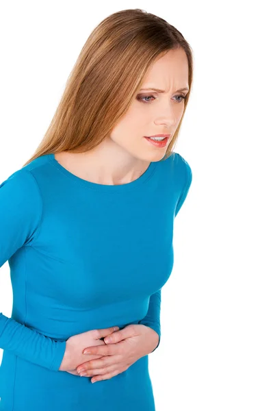 Woman holding hands on stomach and looking away — Stock Photo, Image