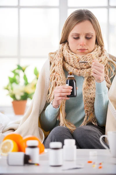 Young woman taking medicines — Stok fotoğraf