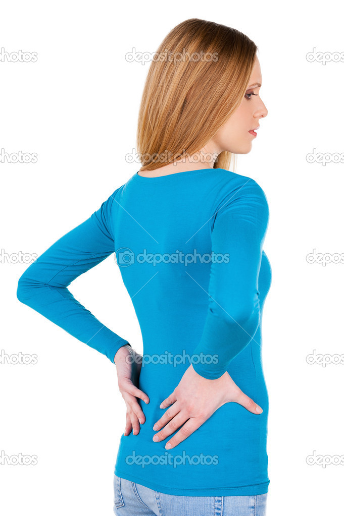 Rear view of woman holding hands on back and looking away