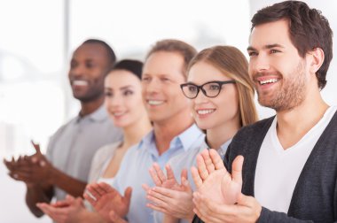 Group of cheerful business people applauding to someone clipart