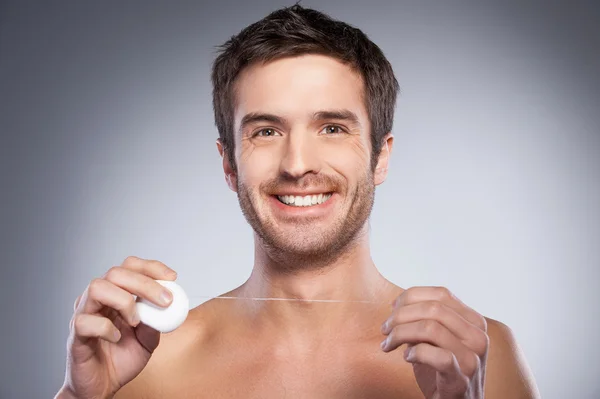 Man with dental floss. — Stock Photo, Image