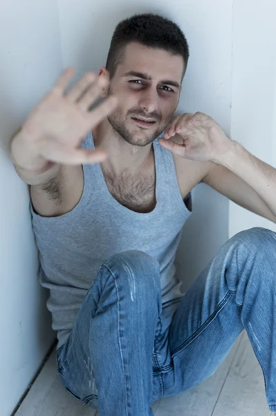 Depressed young man sitting on the floor — Stock Photo, Image