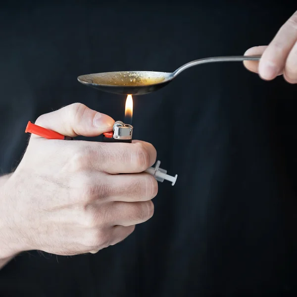 Man boiling heroin. — Stock Photo, Image