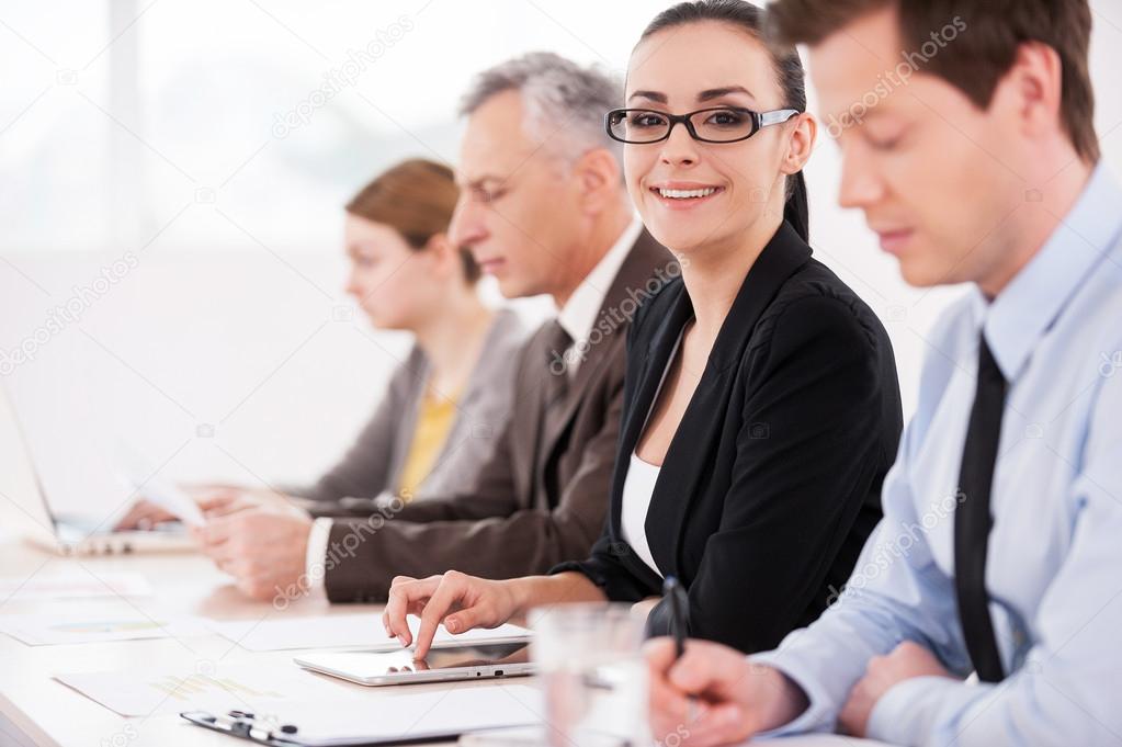 Confident business people sitting in a row