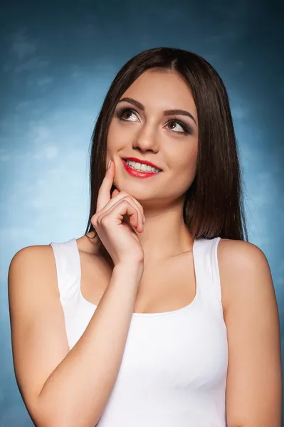 Woman holding finger on chin — Stock Photo, Image