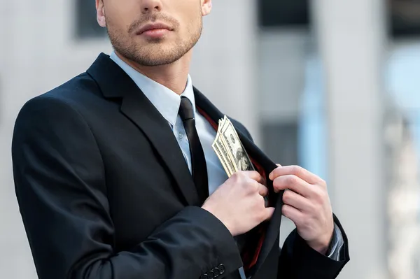 Pocketing company money. — Stock Photo, Image