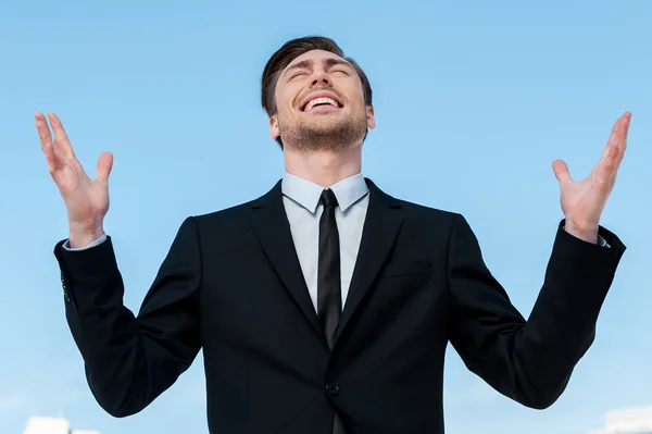 Jeune homme en costume levant les mains — Photo