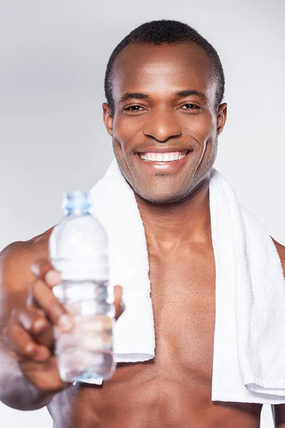 African man stretching out a bottle — Stock Photo, Image