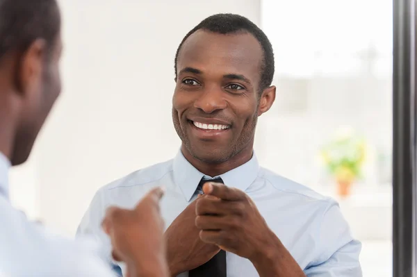African man adjusting his necktie — Stock Photo, Image