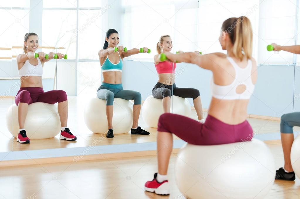 Women exercising with dumbbells.