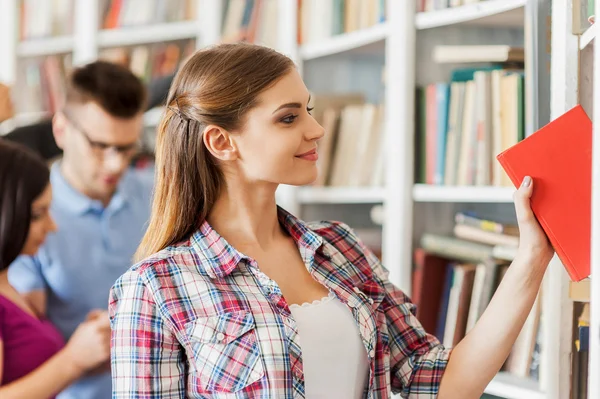 Frau sucht ein Buch aus — Stockfoto