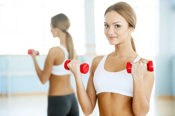 Woman with dumbbells. Royalty Free Stock Images