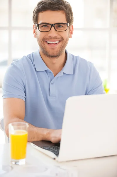 Knappe jonge man die op laptop werkt — Stockfoto