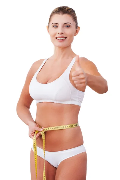 Woman in underwear measuring her waist — Stock Photo, Image