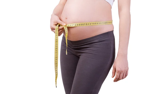 Measuring her pregnant belly. — Stock Photo, Image