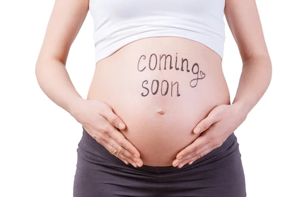 Pregnant woman with coming soon sign — Stock Photo, Image