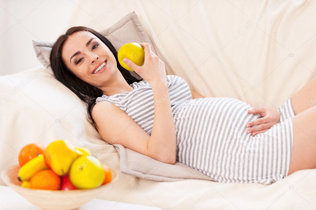 Pregnant woman eating a fruit salad