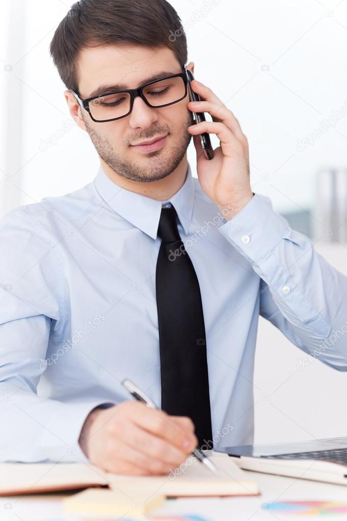Man in shirt and tie talking on phone