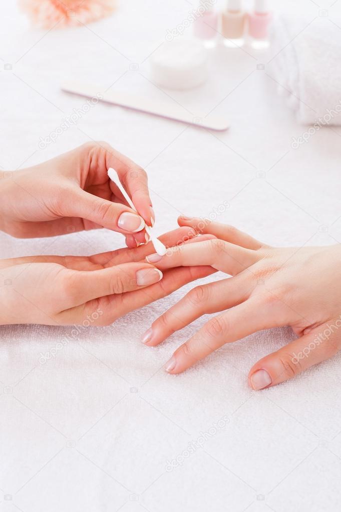 Preparing nails for manicure.