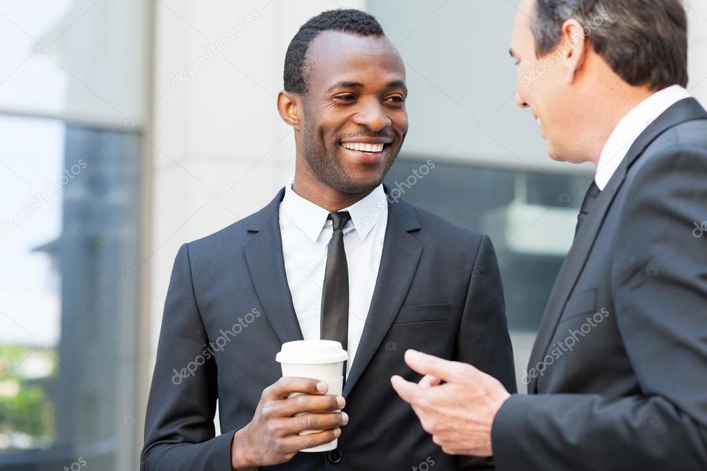 Businessmen talking during coffee break.