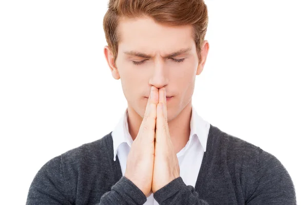 Man holding hands clasped near mouth — Stock Photo, Image