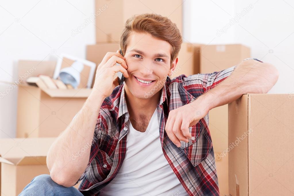 Man sitting on floor and talking on phone
