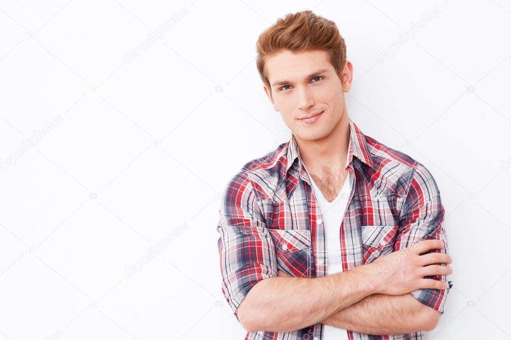 Young man keeping arms crossed