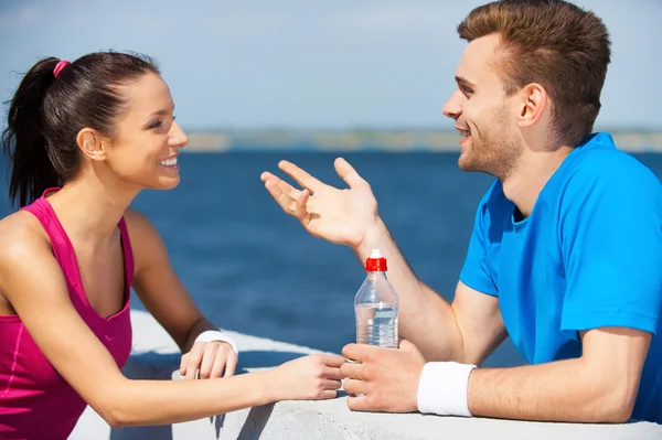 Couple in sports clothing talking Stock Image