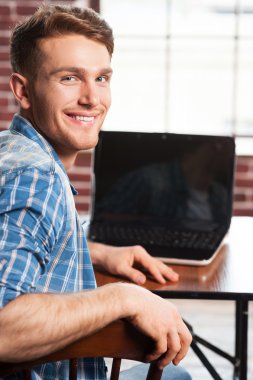 Young man at his working place clipart