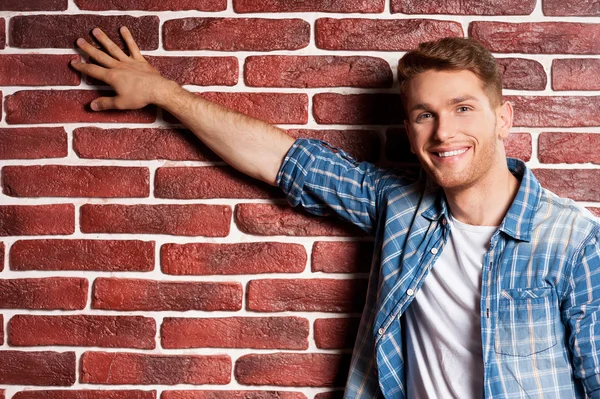 Hombre tocando una pared de ladrillo — Foto de Stock