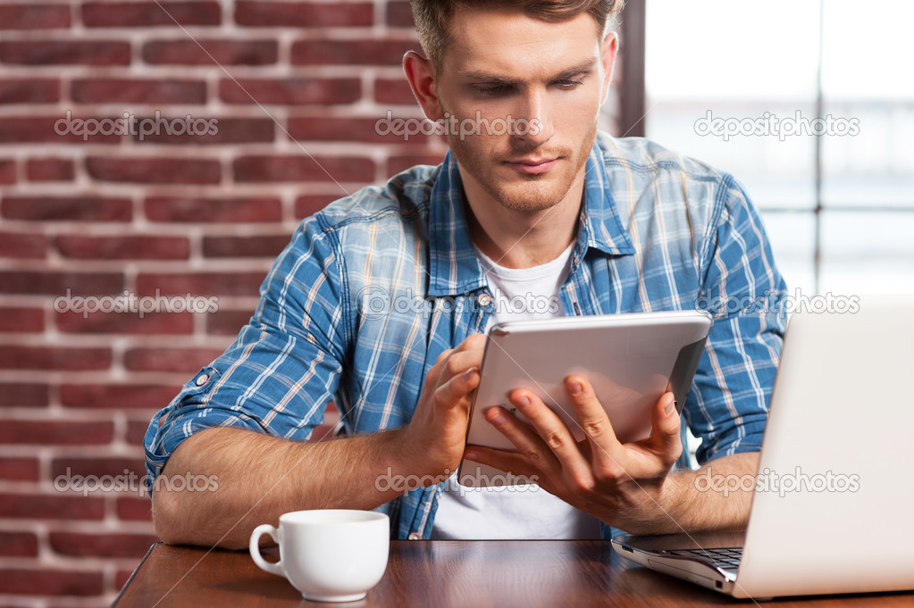 Man working on digital tablet