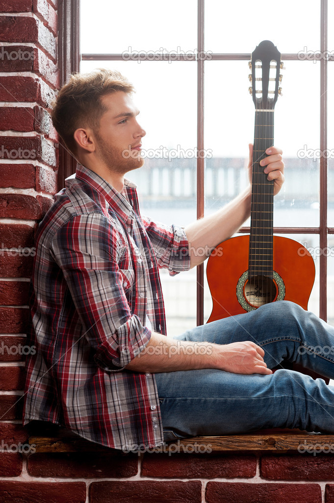 Man holding acoustic guitar