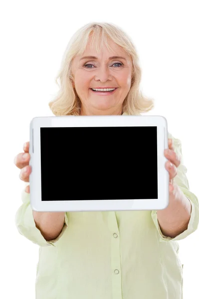 Senior woman showing digital tablet — Stock Photo, Image