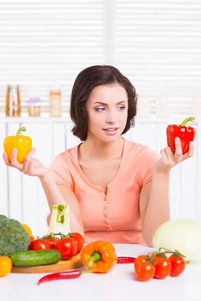 Woman holding colorful peppers in hands — Stock Photo, Image