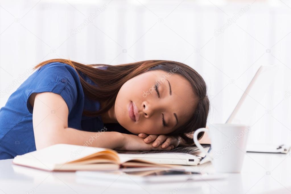Asian woman sleeping at working place