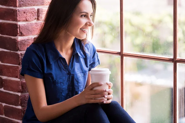 Woman holding cup of hot drink — Stock Photo, Image