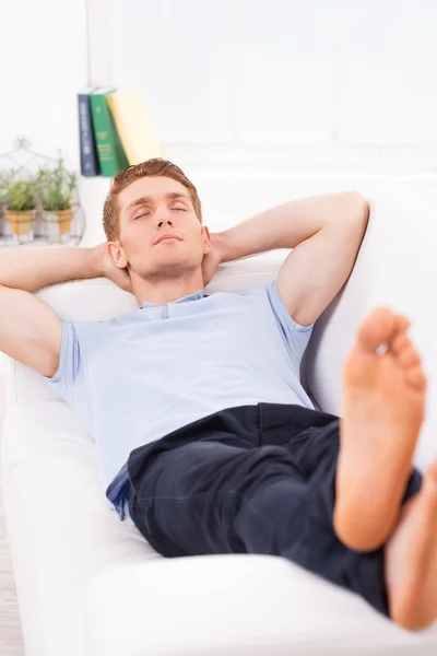 Man lying on the couch — Stock Photo, Image