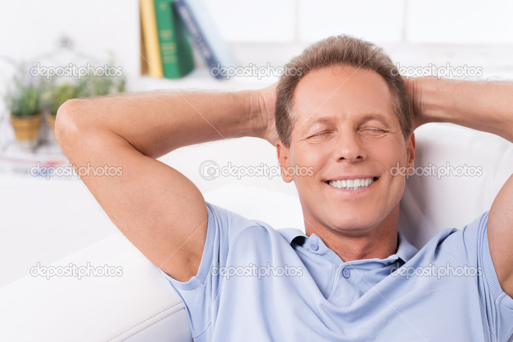 Mature man lying on couch