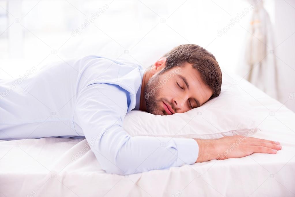 Man in shirt sleeping in bed