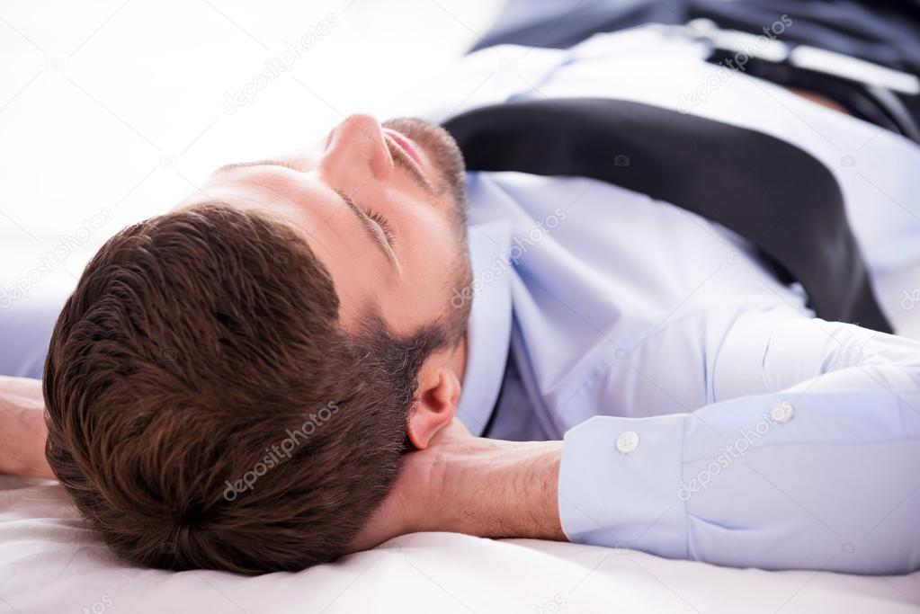 Young man in shirt sleeping in bed
